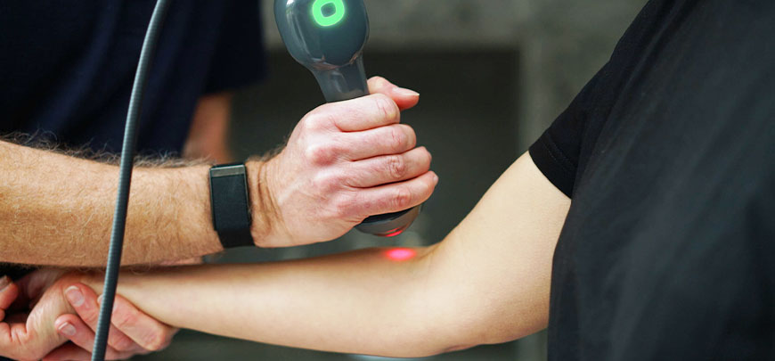 patient receiving class iv laser therapy to relieve elbow pain